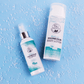 pure magnesium oil spray and lotion bottles on a textured blue surface. Infused with Dead Sea magnesium chloride, they promote skin nourishment and muscle recovery.