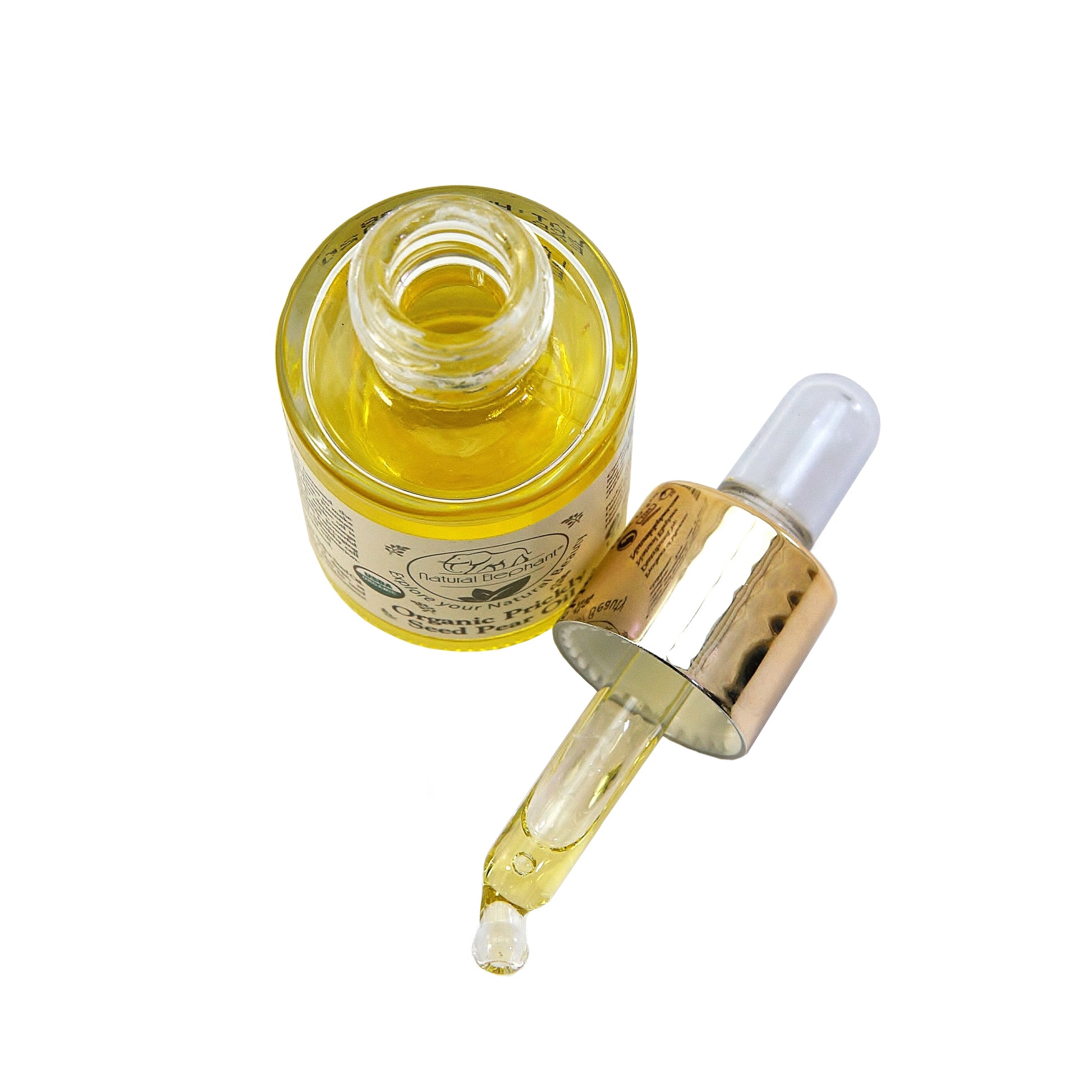 A close-up of an open prickly pear seed oil bottle with a dropper filled with golden oil. This organic, vitamin E-rich face serum is designed for hydration and skincare.